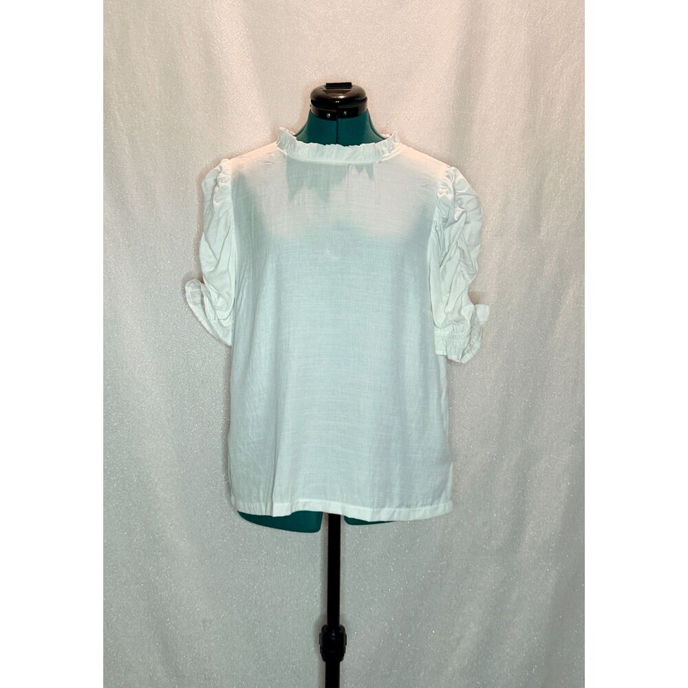 Vine & Love white short-sleeve blouse with a ruffled high neckline